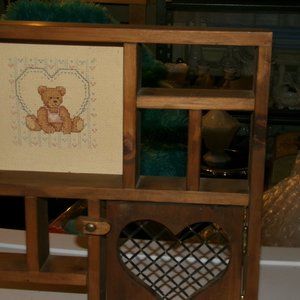 wooden wall trinket shelf. with cross stitch .